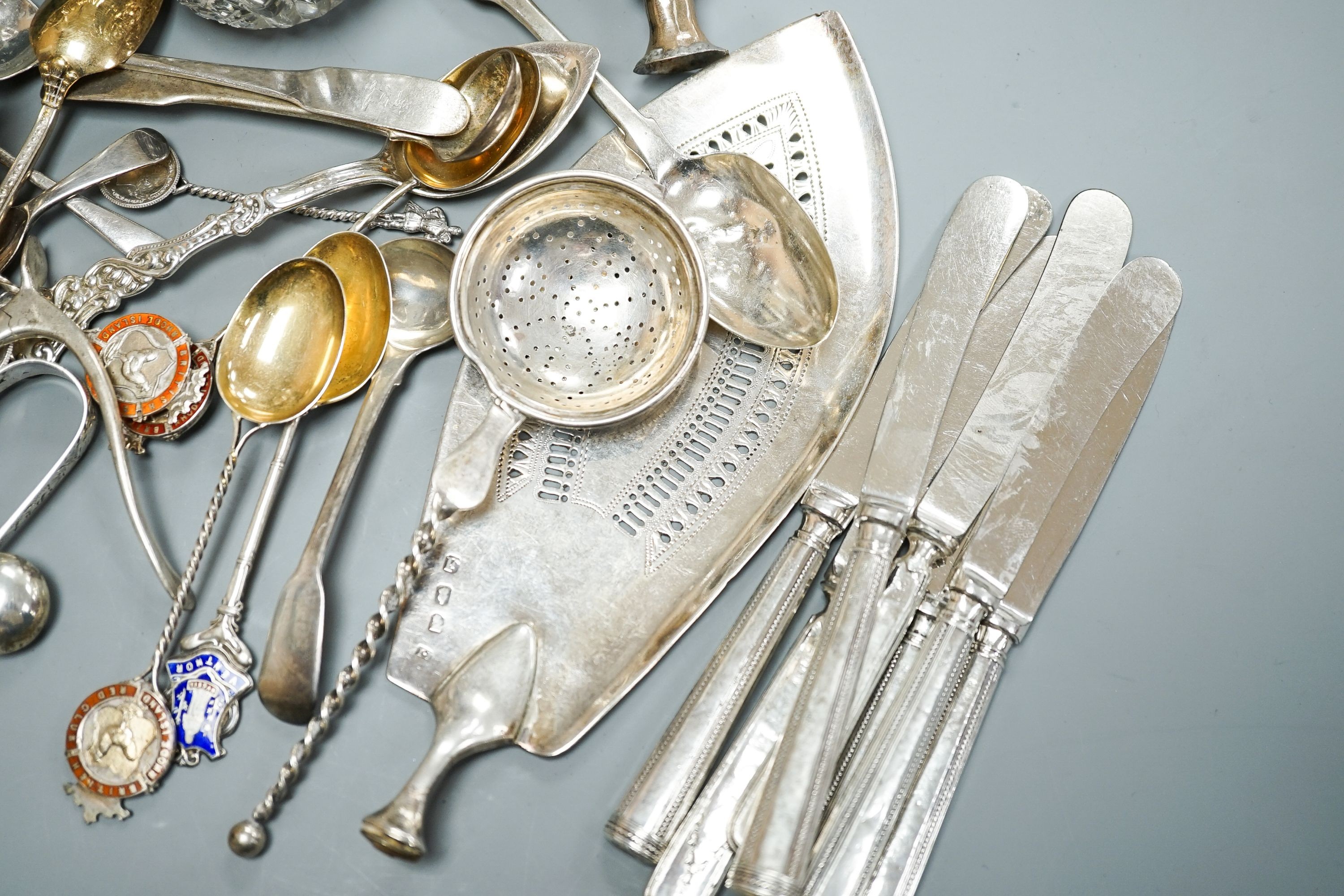 A mixed collection of sundry English and other silver to include a cigarette case, wishbone sugar nips, scent bottle, mixed cutlery, napkin rings, trinket box, etc. (some a.f.) and some plated items.